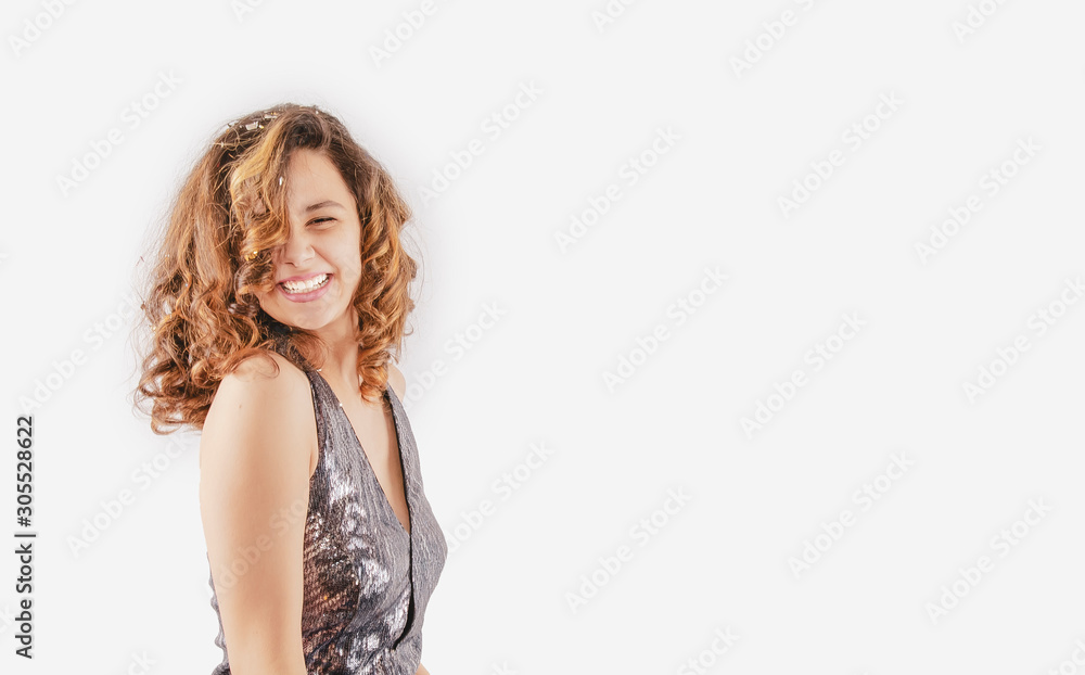 Vivacious dark-haired laughing girl in a brilliant dress, studio portrait isolated on light background. Copy space Vivacious dark-haired laughing girl in a brilliant dress, studio portrait isolated on light background. Copy space