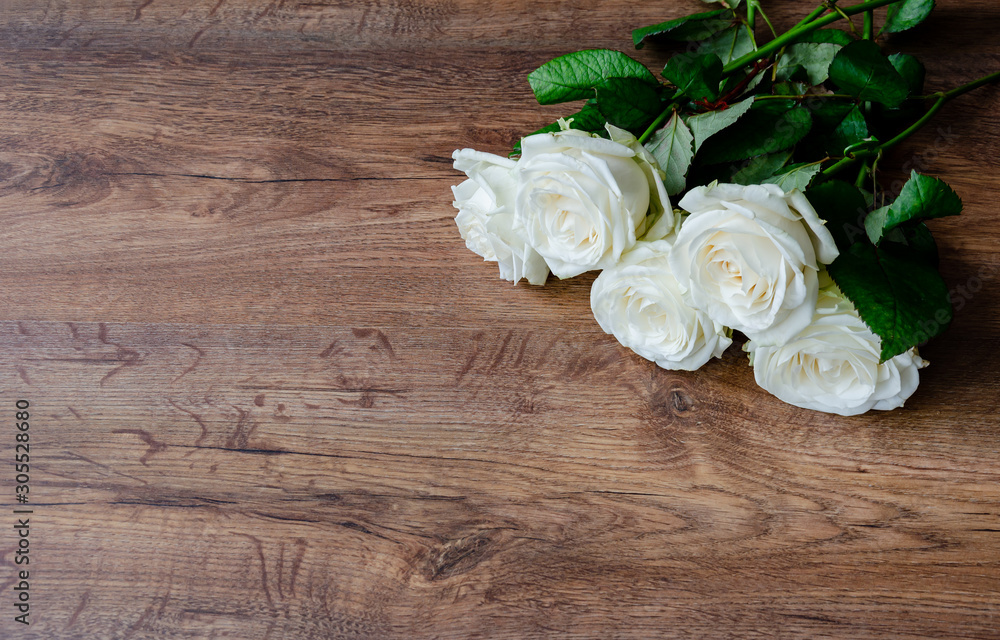 white rose flowers on a wooden background, vintage toned