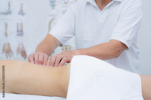Young woman receiving back massage in a physiotherapy center