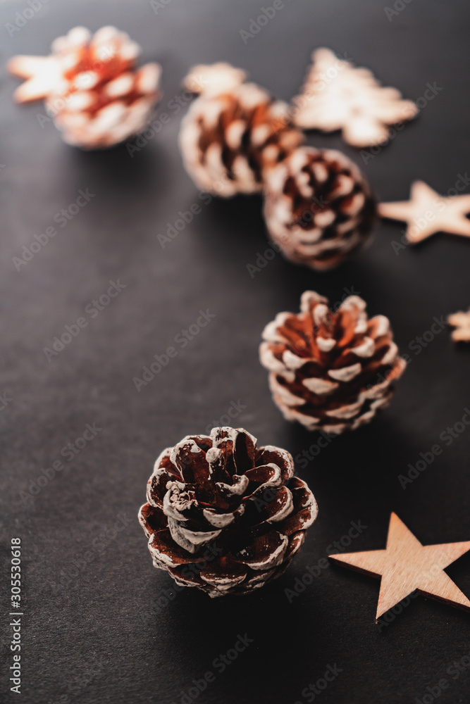 wooden winter elements, pine cone isolated on black background, beautiful christmas decoration wooden winter elements, pine cone isolated on black background, beautiful christmas decoration