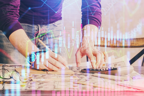 Multi exposure of man standing and planing investment with stock market forex chart.