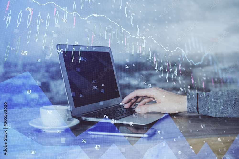 Double exposure of businessman's hands with laptop and stock market graph background. Concept of research and trading. Double exposure of businessman's hands with laptop and stock market graph background. Concept of research and trading.