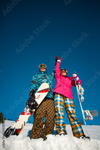 A pair of snowboarders on a slope