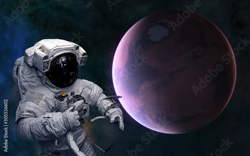 Fototapeta Naklejka Na Ścianę i Meble -  Astronaut on background of Mars. Red planet of the solar system. Science fiction. Elements of this image furnished by NASA