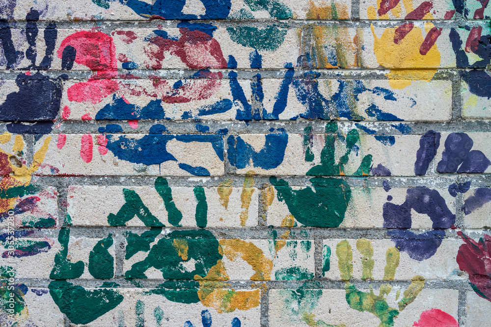 Fototapeta premium Wall with handprints on a playground.