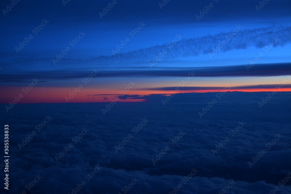 Fototapeta premium flying above the clouds in the evening