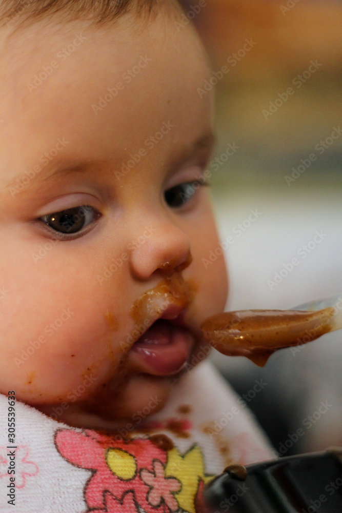 baby girl dirty with baby food is fed baby girl dirty with baby food is fed