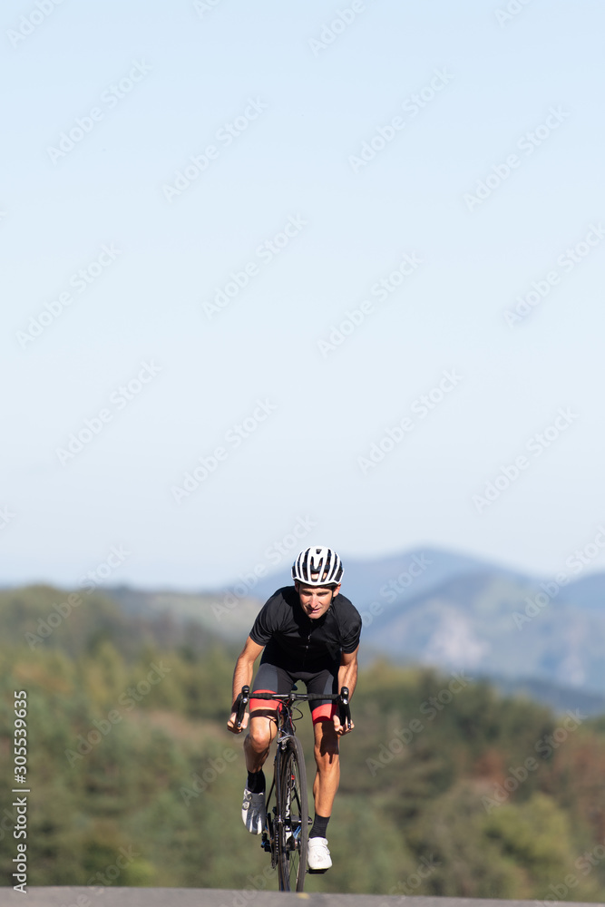 Professional cyclist riding bike in park