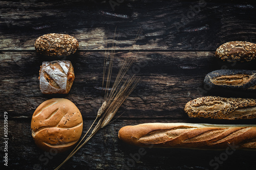 Gold assortment bread homemade on dark wood background, captured from above top view, flat lay in knolling concept photo