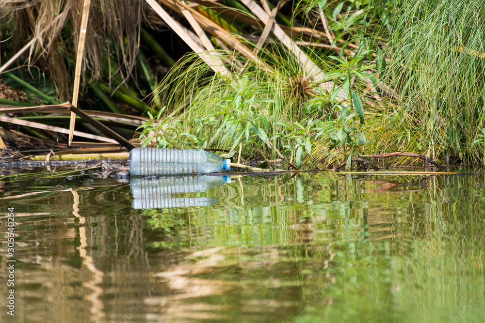 Empty plastic bottle thrown away in the water, litterin in the national park, Lake Mburo, Uganda, Africa. Empty plastic bottle thrown away in the water, litterin in the national park, Lake Mburo, Uganda, Africa.