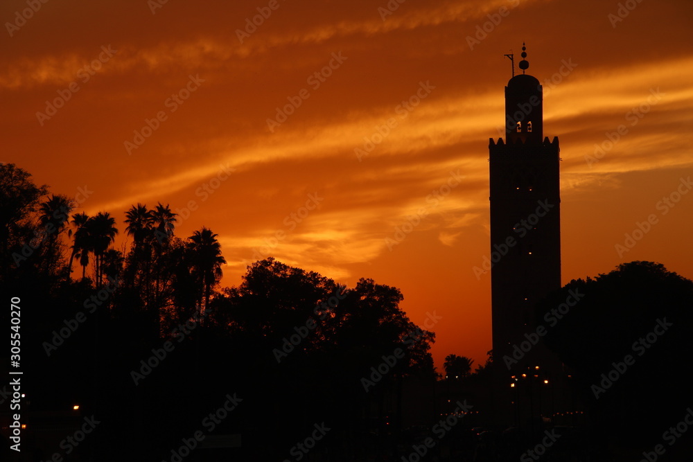 Orange sunset in the tower of the Marrakech square. Morocco