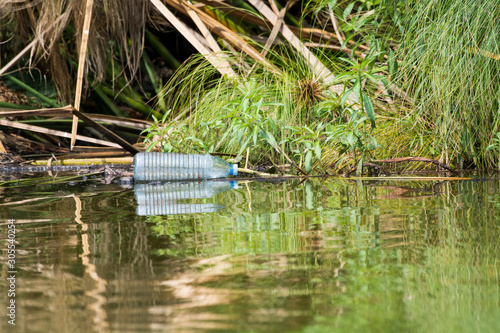 Empty plastic bottle thrown away in the water  litterin in the national park  Lake Mburo  Uganda  Africa.
