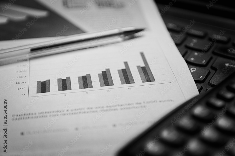 Statistical graphs next to a calculator and a computer Statistical graphs next to a calculator and a computer