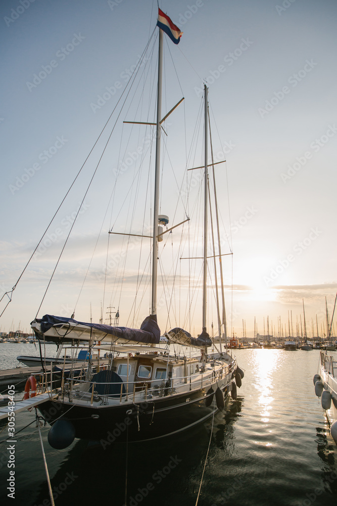 Exquisite yachts moored in calm water in bright day in Port Valencia, Spain Exquisite yachts moored in calm water in bright day in Port Valencia, Spain