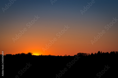 A fiery sunset in summer with clear sky