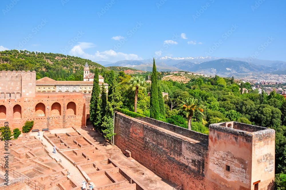 Alhambra palace and gardens with Sierra Nevada mountains at background, Granada, Spain