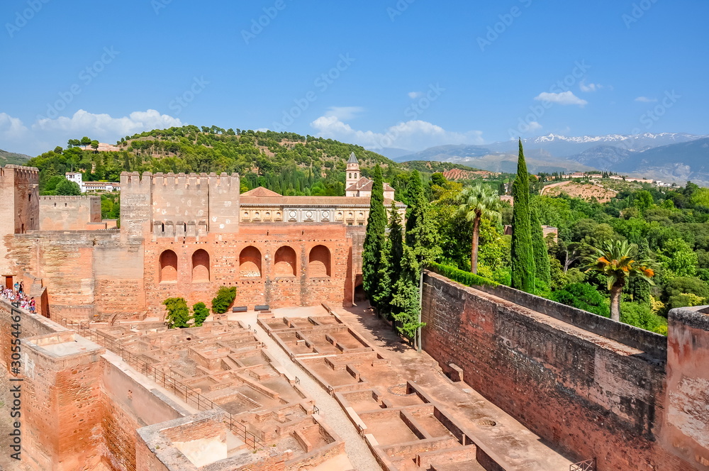 Alhambra palace and gardens with Sierra Nevada mountains at background, Granada, Spain