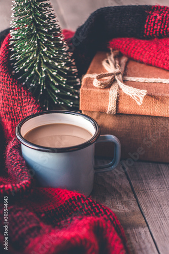 Hot coffee mug wrapped in a scarf with winter details