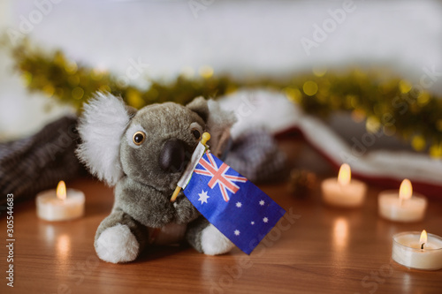 Canvas Print A koala bear with an Australian flag with Christmas decoration background