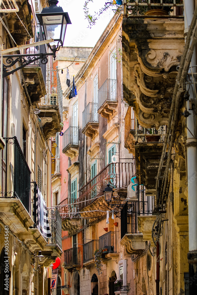 Baroque and ancient alley in the city of Syracuse in Sicily, Italy