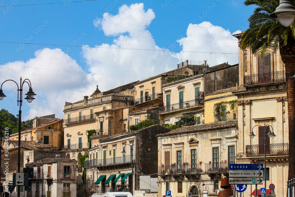 Modica, Italy - August 18, 2018: some old houses on a summer day in the town of Modica in Sicily, Italy