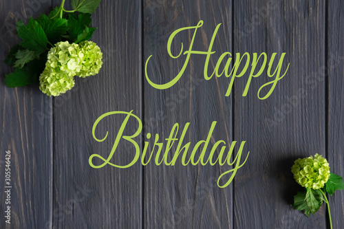 Photography Happy birthday greeting card with flowers on a gray wooden background