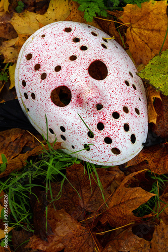 Scary hockey mask lying on the ground photo