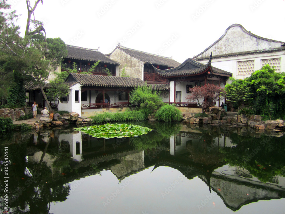 Traditional Chinese house by a pond (with water reflection), near Shanghai, China Traditional Chinese house by a pond (with water reflection), near Shanghai, China