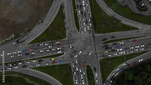 Top down aerial view of road intersection with crowded vehicles