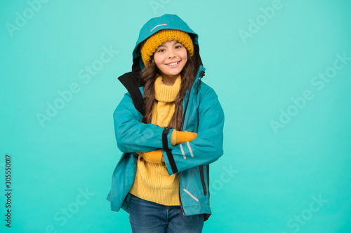 Best holiday. happy girl anorak jacket. Winter holidays. knitted clothes fashion. cold season weather. outdoor activity for kids. small girl sweater. hat and gloves accessory. warm clothes sales