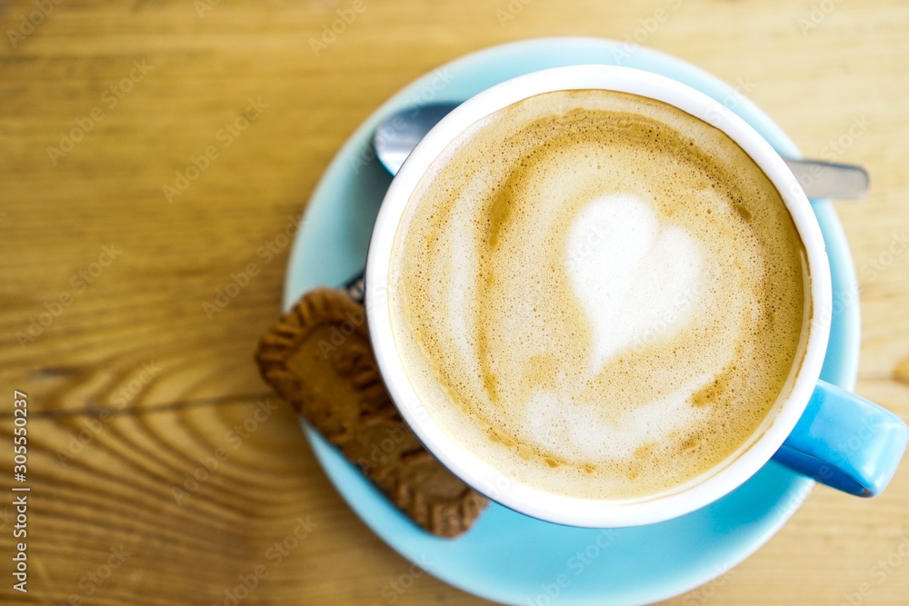 Cafe latte with a biscuit