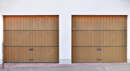 Fotografia Two brown garage doors in a European city. Two garages