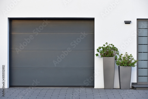 Obraz na plátně Modern gray garage, next to the Scandinavian-style house