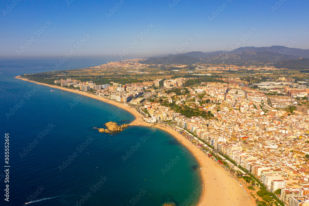 Costa Brava air panorama in Blanes with sea coast line and city landscape. Catalunya, Spain, drone footage, natural light.