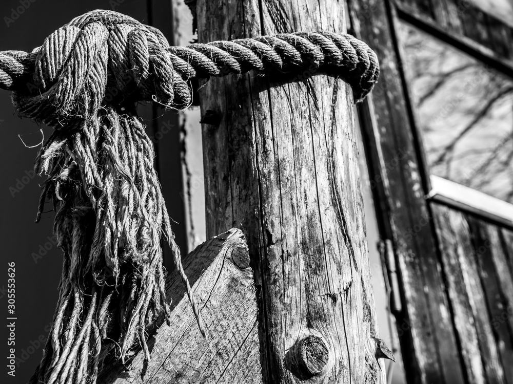 Closeup picture of an old thick rope knot. Black and white detail