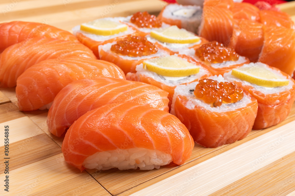Sushi set with salmon. Philadelphia., with caviar. With ginger and wasabi. Close-up. Sushi set with salmon. Philadelphia., with caviar. With ginger and wasabi. Close-up.