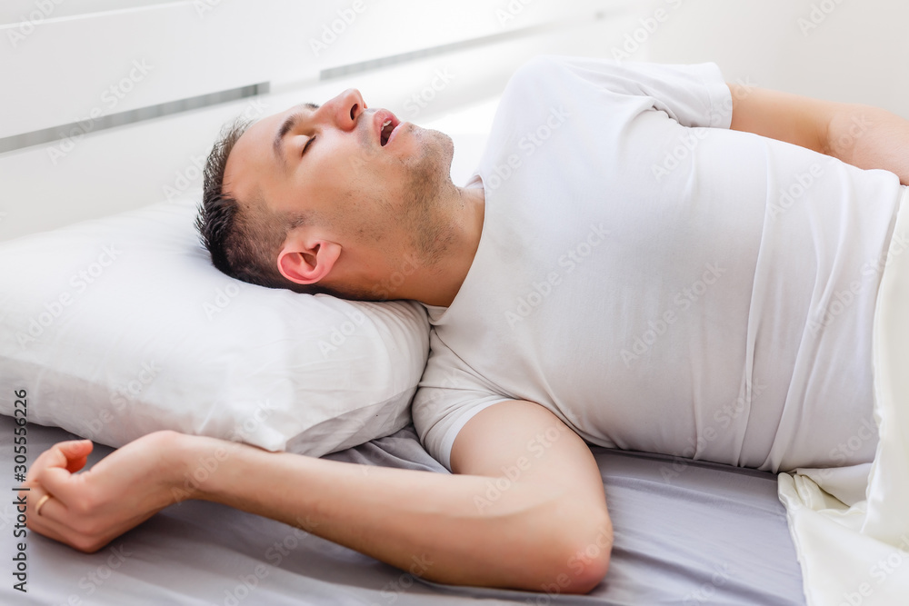 Serene man sleeping in his bedroom Serene man sleeping in his bedroom
