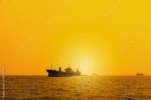 Silhouette Logistics and transportation of International Container Cargo ship in the ocean at Sunshine sky, Freight Transportation, Shipping