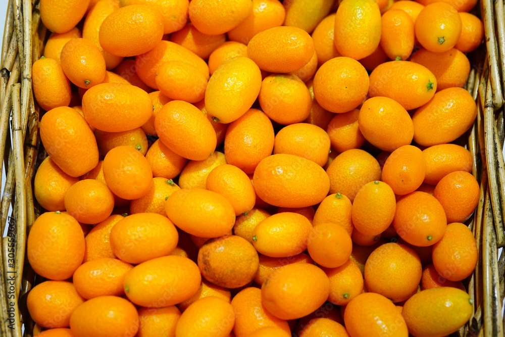 Basket of ripe orange kumquat citrus fruit Basket of ripe orange kumquat citrus fruit