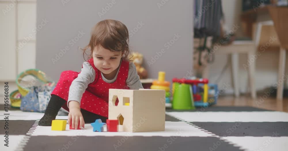 Toddler playing with wooden toy blocks. Shot in 4K RAW on a cinema camera. Toddler playing with wooden toy blocks. Shot in 4K RAW on a cinema camera.