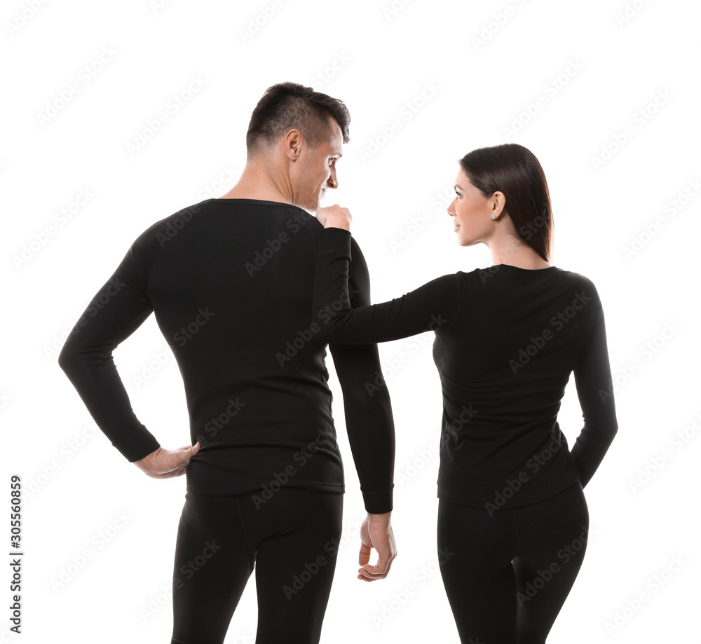 Couple wearing thermal underwear isolated on white, back view Couple wearing thermal underwear isolated on white, back view