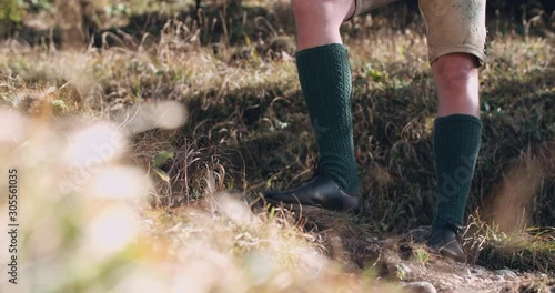 Close up slow motion shot, traditional European music costume, shoes and socks, nature, Alps. 4K.