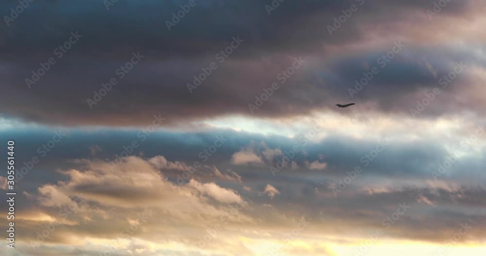 A plain crossing the sky with clouds background A plain crossing the sky with clouds background