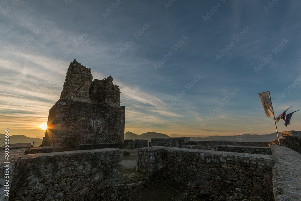 Sun rizing behind the Smlednik old castle ruins Sun rizing behind the Smlednik old castle ruins