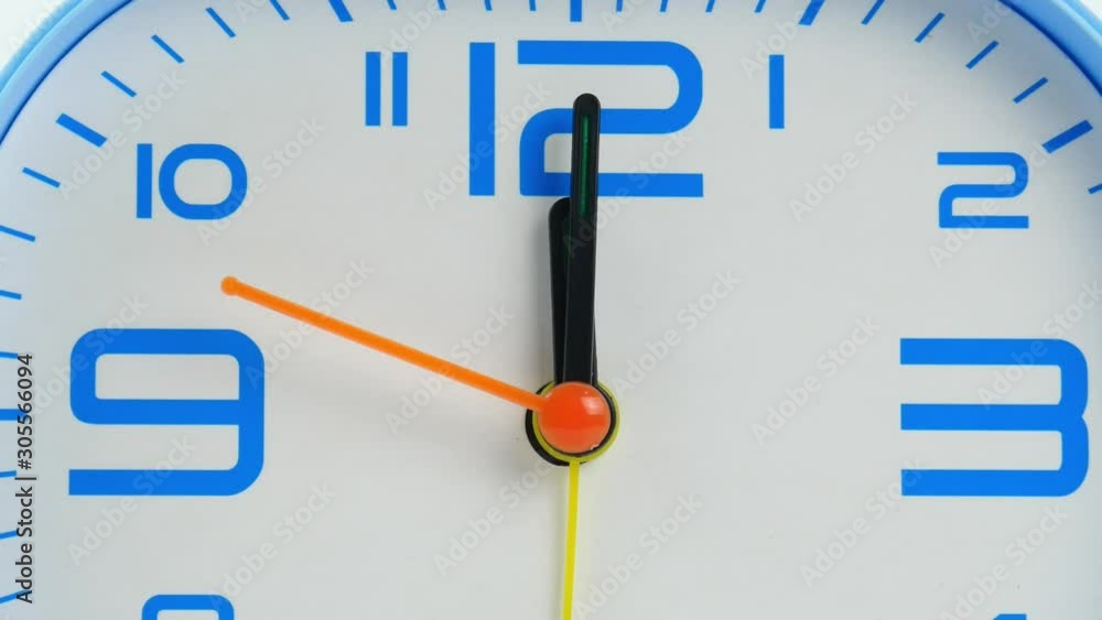 Closeup Zoom out, Twelve o'clock Blue Alarm clock face beginning of time 12.00 am or pm on White background. Closeup Zoom out, Twelve o'clock Blue Alarm clock face beginning of time 12.00 am or pm on White background.