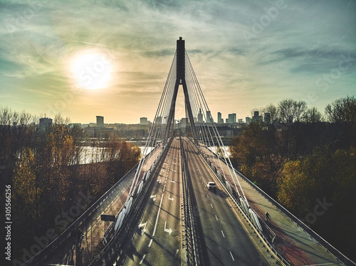 Beautiful panoramic aerial drone sunset view to Warsaw city center with skyscrapers and Swietokrzyski Bridge (En: Holy Cross Bridge) - is a cable-stayed bridge over the Vistula river in Warsaw, Poland
