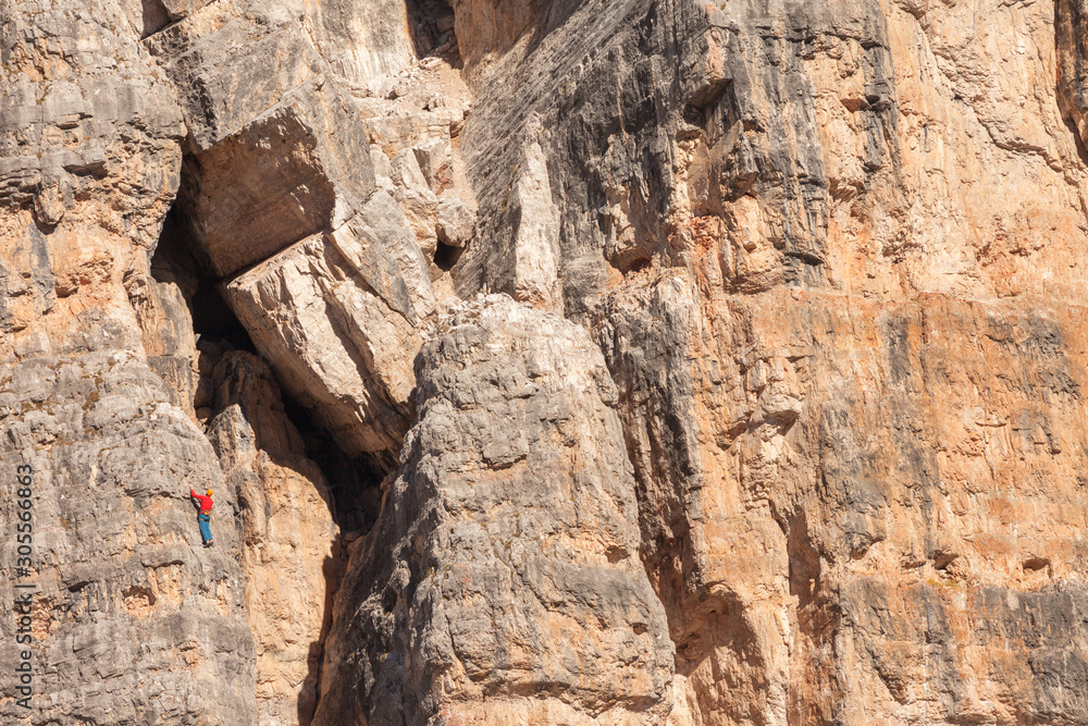 Rock climbers in action over a vertical cliff in the Cinque Torri area in Dolomites Rock climbers in action over a vertical cliff in the Cinque Torri area in Dolomites