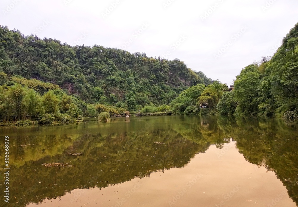 a beatiful lake with green trees and reflection in the water a beatiful lake with green trees and reflection in the water