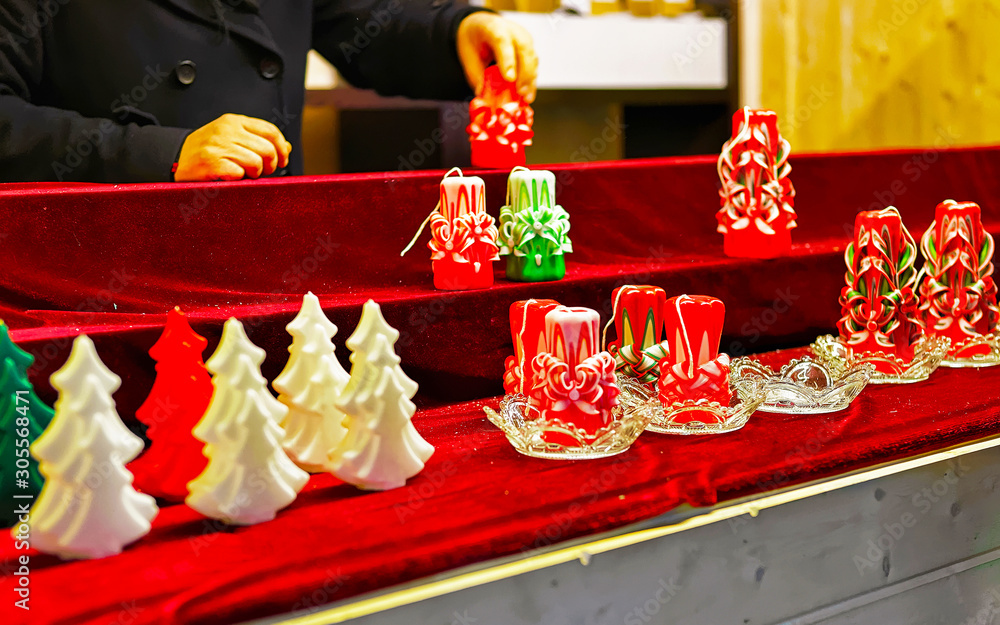 Wax candles at Christmas Market in Winter Vilnius, Lithuania. Advent Fair Decoration and Stalls with Crafts Items on the Bazaar. Lithuanian street Xmas and holiday in European city