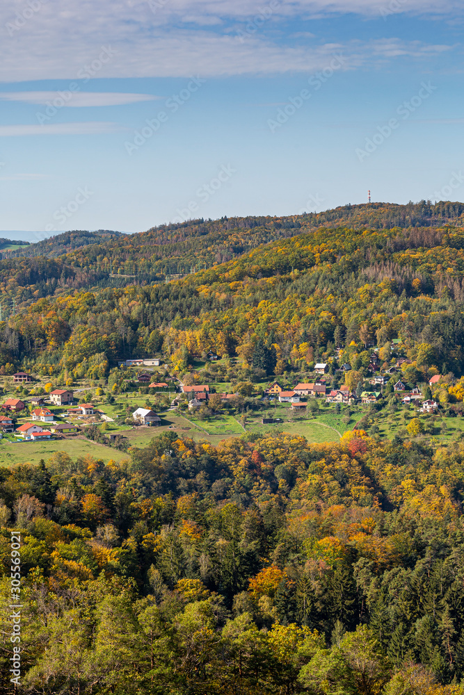Autumn landscape of Central Bohemia from the Vltava River. Colorful autumn trees, village Trebenice and Slapy dam as background. Autumn landscape of Central Bohemia from the Vltava River. Colorful autumn trees, village Trebenice and Slapy dam as background.